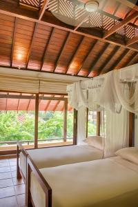 A bed or beds in a room at Jetwing Ayurveda Pavilions - Full Board & Treatments