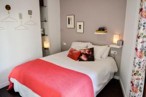 塞維利亞的住宿－AlohaMundi Campana，卧室配有一张带红色毯子的白色床