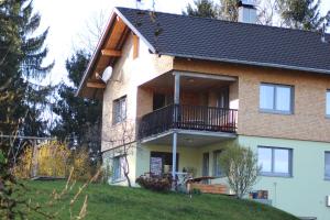 a house with a balcony on top of a hill at Naturparadies Silvia in Alberschwende