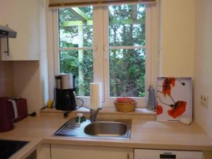 a kitchen counter with a sink and a window at Ferienwohnung Doelling in Ausacker
