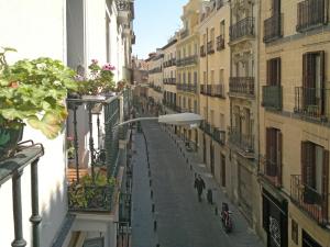 an empty city street with people walking down the street at Hostal San Antonio in Madrid