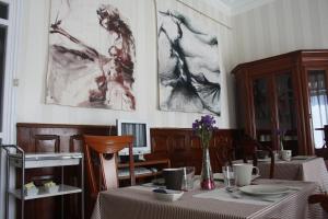 a dining room table with a painting on the wall at Plaza Pombo B&B in Santander