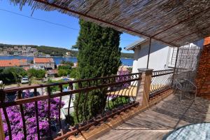 a view from the balcony of a house with purple flowers at Nina in Mali Lošinj