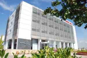 a large white building with a sign on it at Orty Airport Hotel in Izmir