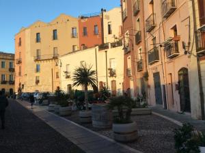 a row of buildings with potted plants on a street at Old castle S. Croce in Cagliari