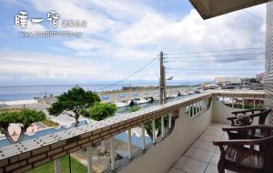 a balcony of a house with a view of the ocean at Happy Holiday Xiaoliuqiu in Xiaoliuqiu