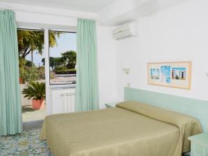 Postel nebo postele na pokoji v ubytování Hotel Parco Cartaromana