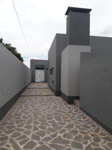 a hallway of a building with a stone floor at Complejo Pirovano in Lincoln