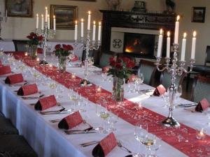 a long table with wine glasses and candles on it at Zámok u Grofa in Nitra