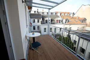a balcony with a table and a view of buildings at Hochweis in Leipzig