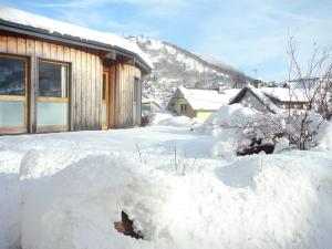 a pile of snow in front of a house at La Demeure des 2 Trésors in La Bresse
