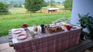 a picnic table with a plate of food on it at Chambres d'Hôtes Relais Milord in Estialescq