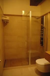 a shower with a glass door in a bathroom at Hotel Arabia in Albarracín