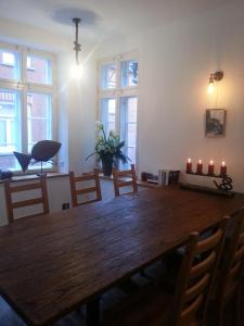 a dining room with a wooden table with candles on it at Lazy Elbfish in Lauenburg