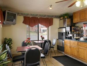 a kitchen with a table and chairs and a dining room at Hillside Inn & Suite in Martinsburg
