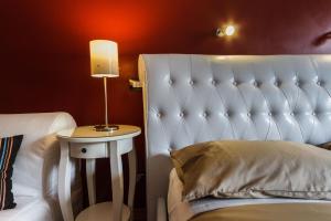 a bedroom with a bed and a side table with a lamp at L'Angolo Cortese in Rome