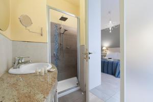 a bathroom with a sink and a shower at Ruins B&B in Ercolano