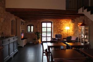 a living room with tables and chairs and a tv at Tenuta Zannafondo in Donnafugata