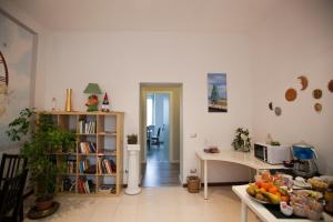 a living room with a table and a book shelf at I Tre Arcangeli LT in Verona