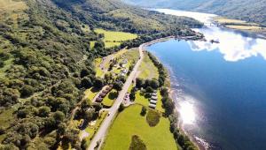 an aerial view of a road next to a lake at Appin Holiday Homes in Appin