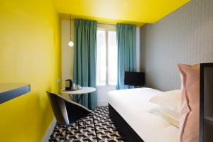 a hotel room with a bed and a window at Hotel Haussmann Saint Augustin in Paris