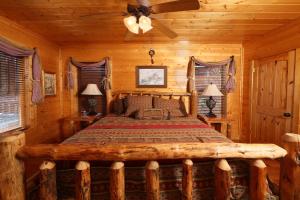 a bedroom with a bed in a log cabin at Howling Wolf in Sevierville