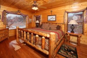 a bedroom with a bed in a log cabin at Howling Wolf in Sevierville
