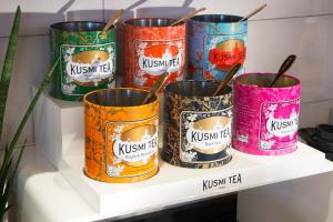 a group of six canisters sitting on a shelf at Hotel Haussmann Saint Augustin in Paris