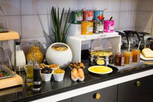 a kitchen counter with a bunch of food on it at Hotel Haussmann Saint Augustin in Paris