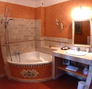 a bathroom with a tub and a sink at La Royante in Aubagne +21 photos