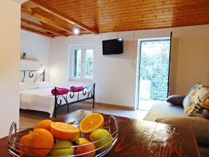 a living room with a bowl of fruit on a table at House Sv. Lovre in Postira