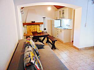 a living room with a couch and a kitchen at House Sv. Lovre in Postira