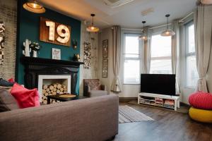 a living room filled with furniture and a fire place at 19 MARY STREET by The Place To Stay Wales in Porthcawl
