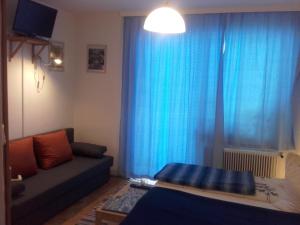 a living room with a couch and a blue curtain at Gasthof Steiner in Mühlen