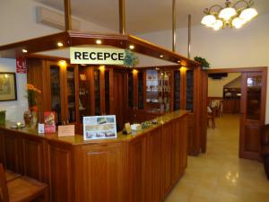 a restaurant with a reception counter with a repurchase at Hotel Pegas Brno in Brno