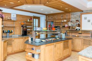 a large kitchen with wooden cabinets and counters at Landhotel Zellerhof in Lunz am See