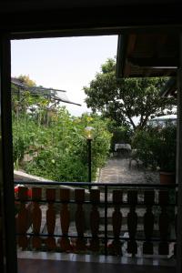 a view of a garden from a window at Appartamenti Serena - Nonna Elvira in Gargnano