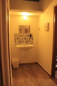 a bathroom with a sink and a mirror on the wall at Verdant Vagamon Cottage in Vagamon