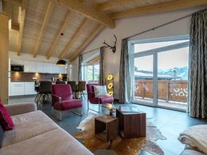 ピーゼンドルフにあるChalet apartment in ski area in Piesendorfのリビングルーム(ソファ、テーブル付)、キッチンが備わります。