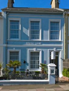a blue house with the words scottish way at South view in Torquay