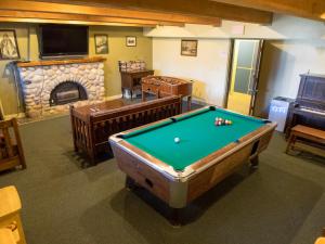 a room with a pool table and a fireplace at Canmore Alpine Hostel - Alpine Club of Canada in Canmore
