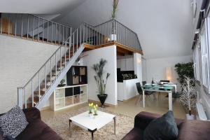 a living room with a staircase and a table at Miramar Ski a pie de pista - ÁTICO DUPLEX , 4 habitaciones in Sierra Nevada