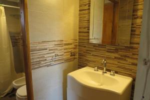 a bathroom with a sink and a toilet at Playa Grande Frente al Mar in San Clemente del Tuyú +22 photos