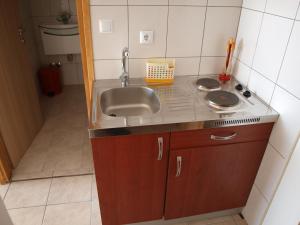 Kuchyň nebo kuchyňský kout v ubytování Apartments Nadia
