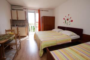 Postel nebo postele na pokoji v ubytování Apartments Nadia