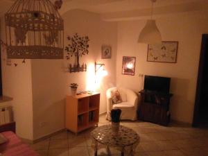 a living room with a chair and a table at La Casetta dei Sogni in Rieti