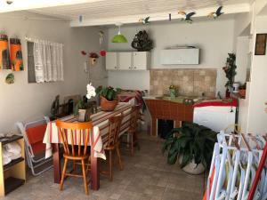 a kitchen and dining room with a table and chairs at Pousada Olena in São Gabriel