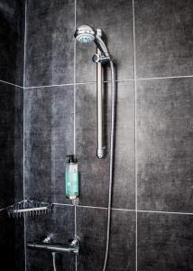 a shower with a shower head in a bathroom at The Rostrevor Inn in Rostrevor