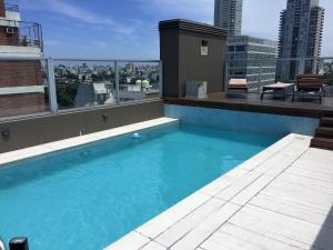 a swimming pool on the roof of a building at Soho Apart in Buenos Aires