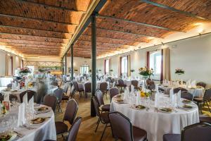 a banquet hall with white tables and chairs at Hotel Karczyce in Karczyce